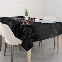 Black tablecloth with MLK portrait graphic and dark folds over table surface