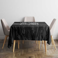 Black tablecloth with MLK portrait and slogan text, rectangular table with chairs