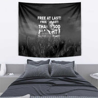 Black wall tapestry with Martin Luther King Jr portrait, quote text, above a made bed