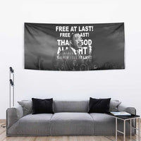 Black wall tapestry with Martin Luther King Jr portrait and quote text above a gray couch
