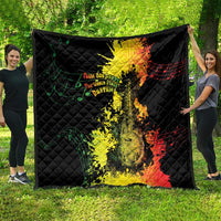 Black quilt blanket spread open on grass with Afro music portrait and notes design