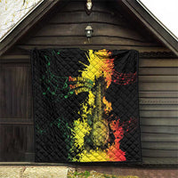 Black quilt blanket hanging on a wooden wall with colorful music artwork