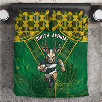 Green bedding set with South Africa text, yellow geometric pattern, and running antelope.