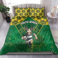 Green duvet and matching pillowcases with South Africa text, yellow pattern, and antelope mascot.