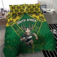 Green duvet and pillowcases with South Africa text, yellow pattern band, and running antelope.