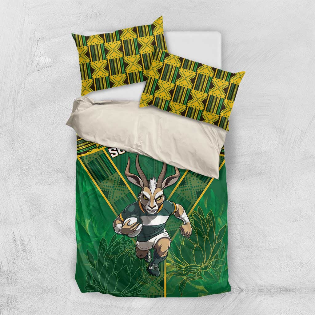 Green bedding set flat lay with South Africa text, yellow geometric pattern, and antelope graphic.