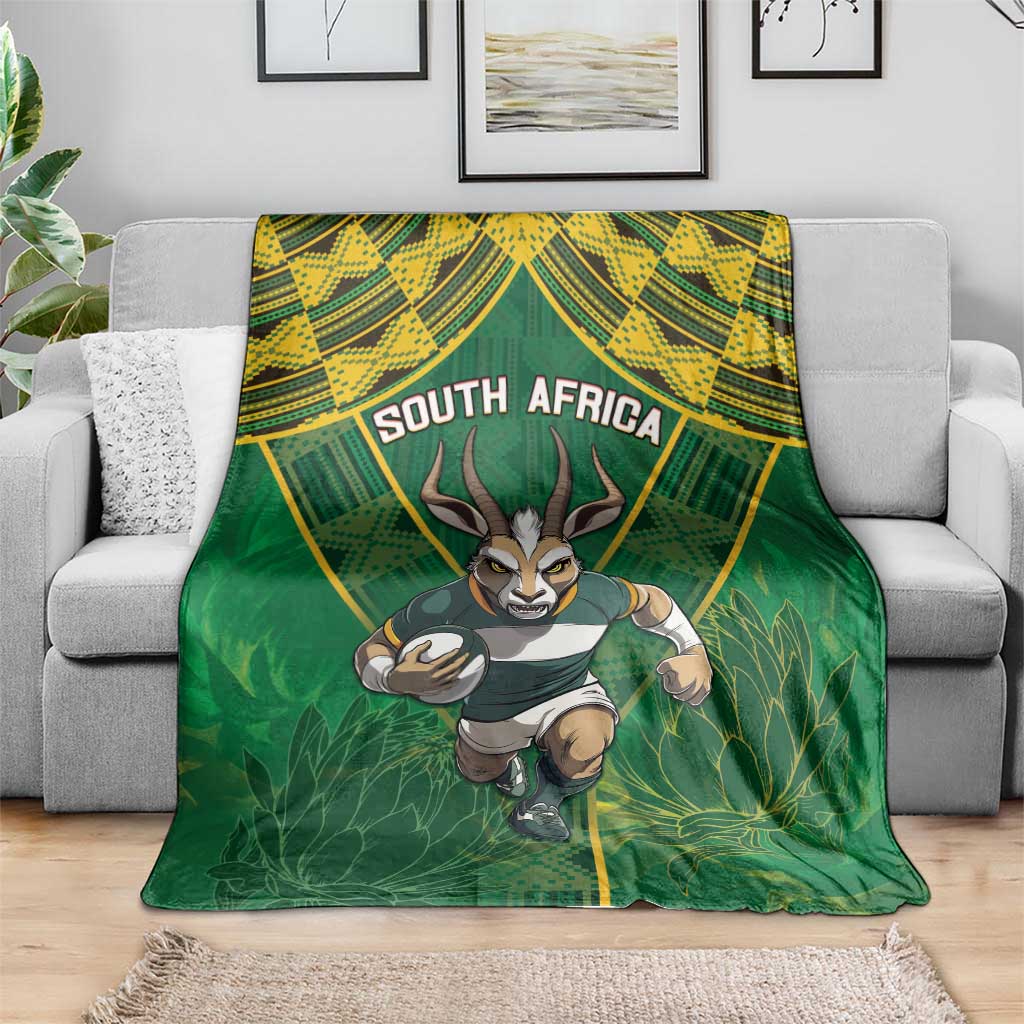 Green throw blanket featuring running springbok, "SOUTH AFRICA" headline, leafy design
