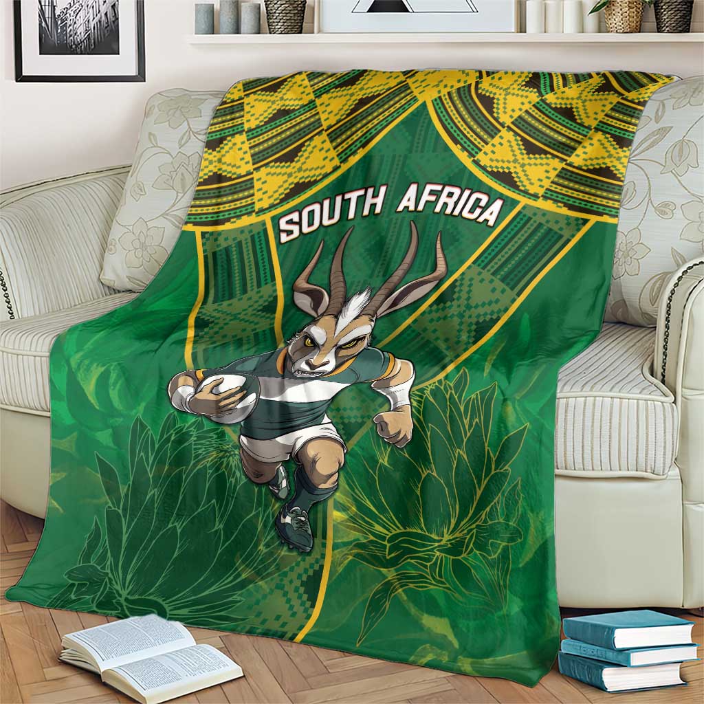 Green blanket draped over furniture, running springbok holding a rugby ball and "SOUTH AFRICA"