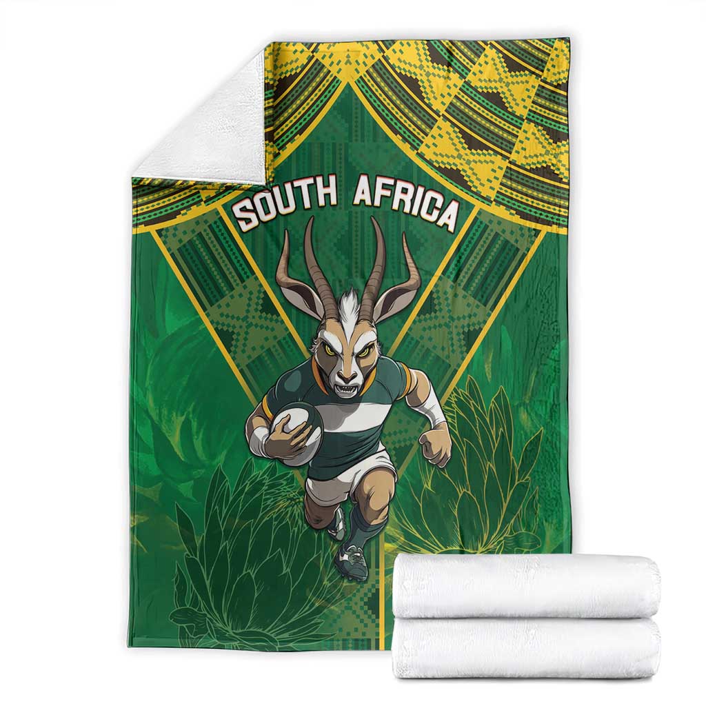 Green blanket with running springbok artwork, "SOUTH AFRICA" text, folded with white stack