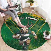 Round green rug with yellow border, South Africa text and running antelope mascot
