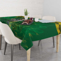 Green tablecloth with yellow edge and animal rugby crest on dining table