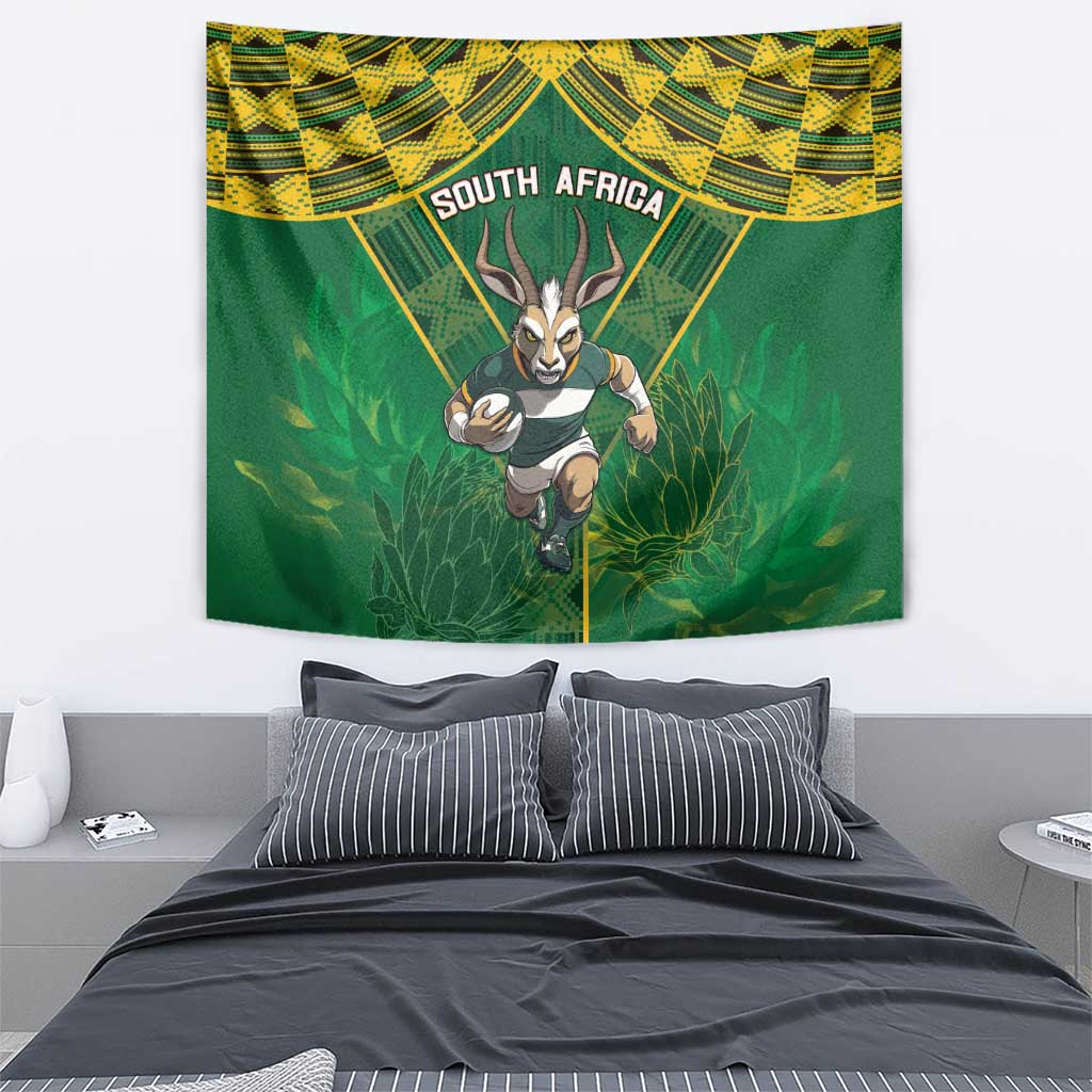 South Africa rugby tapestry above bed, green and yellow geometric border with antelope mascot