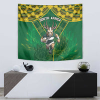 South Africa rugby tapestry on white wall, green field with yellow patterns and antelope graphic