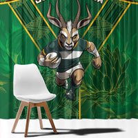 Green window curtain with gold African pattern and antelope mascot print