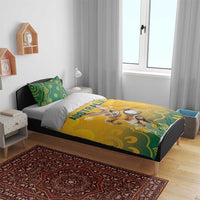 Australia bedding set on bed: yellow duvet with kangaroo and “AUSTRALIA”, green pattern pillowcases