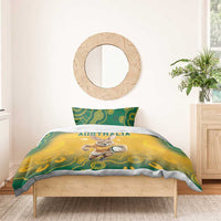 Australia bedding set on wooden bed frame: yellow duvet with kangaroo and green Aboriginal designs