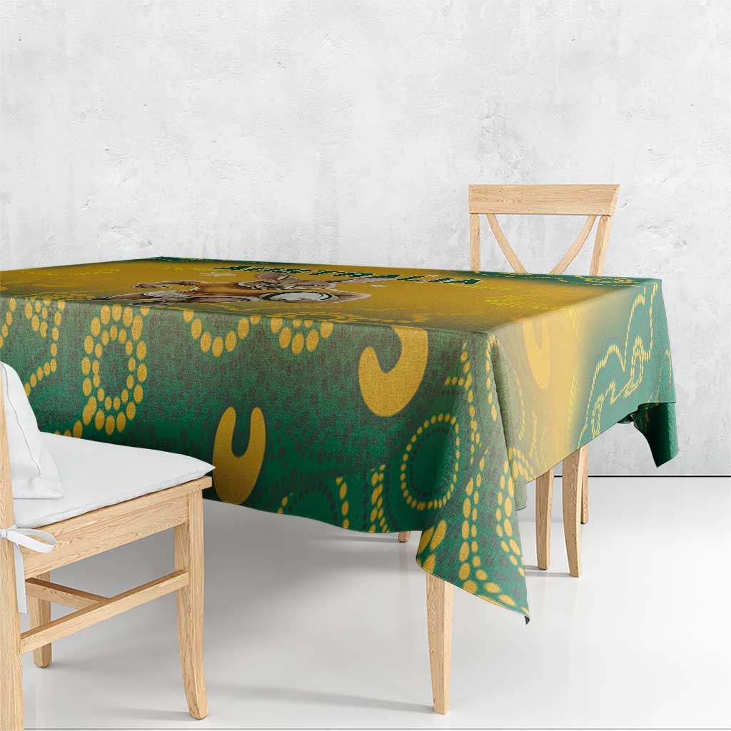 Yellow and green Aboriginal pattern tablecloth draped over rectangular table