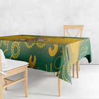 Yellow and green Aboriginal pattern tablecloth draped over rectangular table