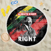 Black round beach blanket with fringed edge, bold portrait and 'RIGHT' typographic graphic