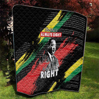 Black quilt with diamond quilting and MLK portrait, surrounded by red, green, and yellow bands