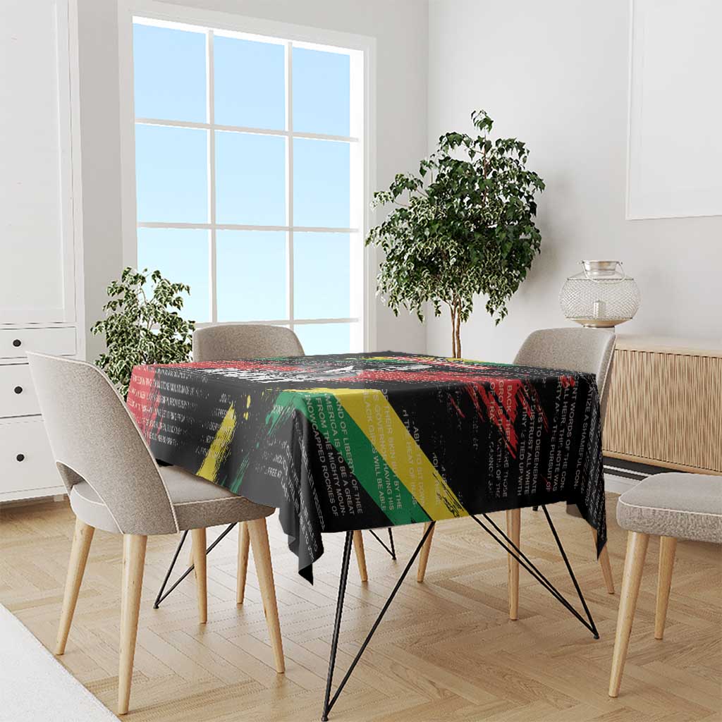 Black tablecloth with colorful diagonal bands and printed celebratory text