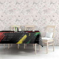 Black tablecloth with colorful diagonal stripe design and printed quote text on table
