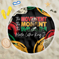 Black round beach blanket with fringe and “The Movement / Martin Luther King Jr” print