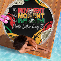 Black round beach blanket with fringe, colorful “The Movement Moment Man” graphic print