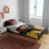 Black bedding set on bed with red, green, and yellow graphic “MOVEMENT MOMENT MAN” print