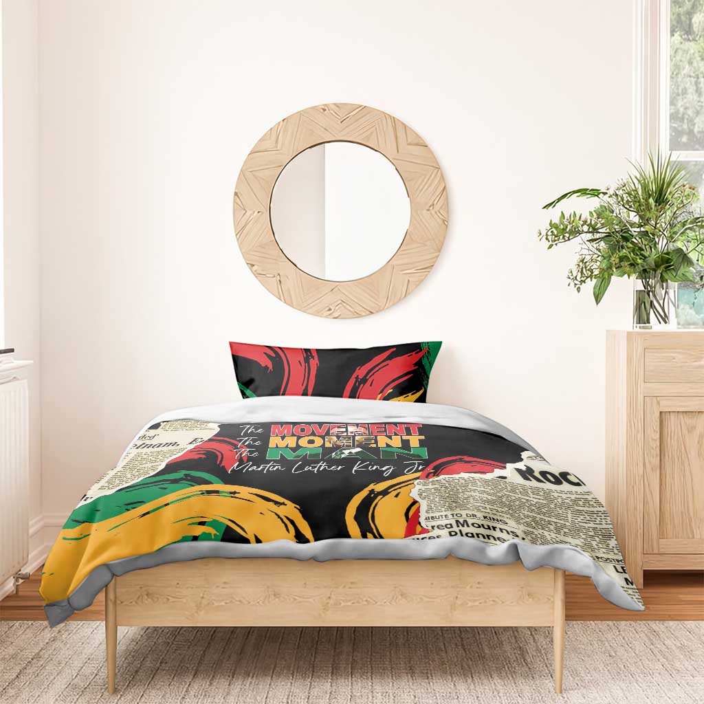 Black bedding set with red, green, and yellow artwork and centered “The MOVEMENT” wording