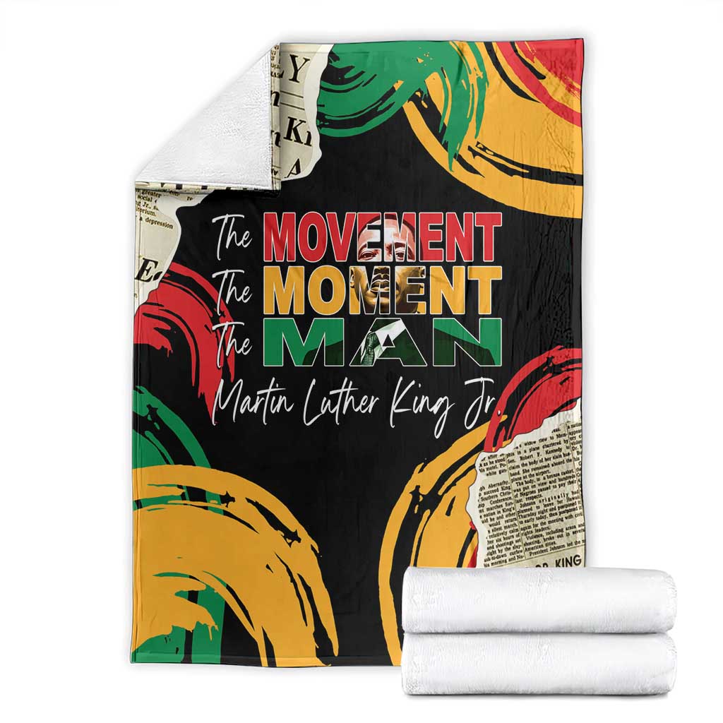 Black MLK legacy blanket with colorful fists and 'The Movement Man' text, folded with rolls
