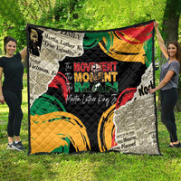 Black quilt spread wide with colorful swirls and portrait-style graphic, quilted texture