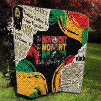 Black quilt with multicolor portrait, bold central lettering-style graphic, quilted stitching