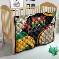 Black quilt with multicolor graphic print and quilted stitching, on child bed frame