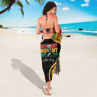 MLK legacy sarong with black base and bold multicolor graphic text, worn wrap style