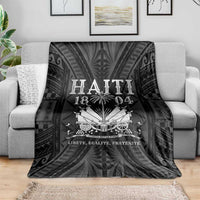 Black decorative blanket on a light gray sofa, “HAITI 1804” and banner text