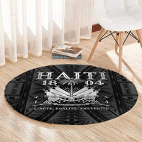 Round Haiti 1804 rug with silver Polynesian-style graphic and text