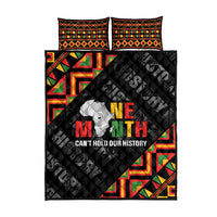 Black quilt bed set with two matching pillows, colorful border, and 'Can't hold our history' graphic