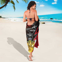 Red and black sarong coat with Antigua and Barbuda crest and deer emblem, back view