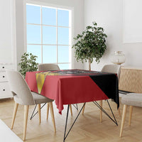 Red and black tablecloth with Antigua and Barbuda coat of arms over dining table