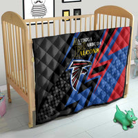 Black cricket quilt blanket on nursery bed frame, Falcons logo with blue and red diagonals