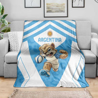 Argentina blanket draped on sofa, featuring blue badge, stripes, and cartoon mascot