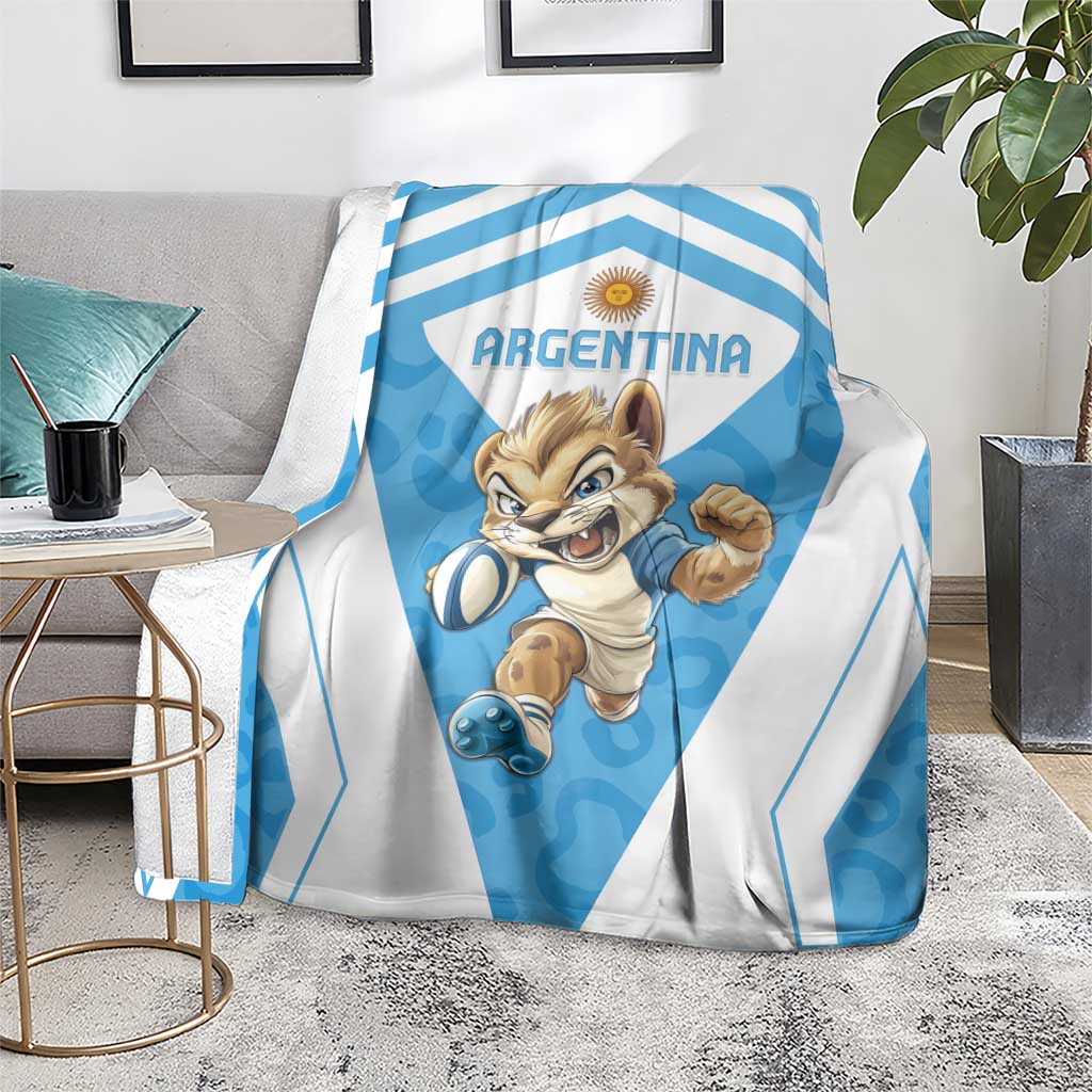 Argentina blanket folded over couch arm, blue stripes and cartoon football mascot