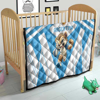 Blue and white Argentina rugby quilt on wooden baby bed with centered cartoon Pumas mascot