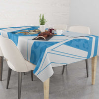 Blue and white tablecloth with bold geometric print on square dining table