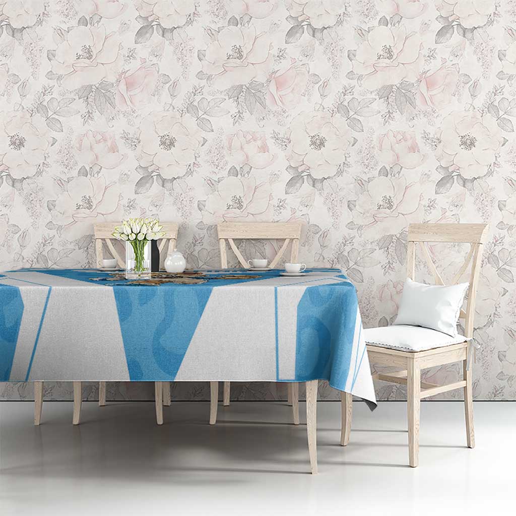 Blue and white tablecloth with geometric print on dining table among chairs