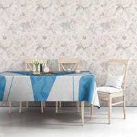 Blue and white tablecloth with geometric print on dining table among chairs