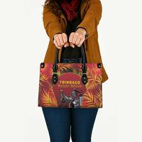 Red fabric tote bag with black handles and TRINBAGO Knight Riders graphic