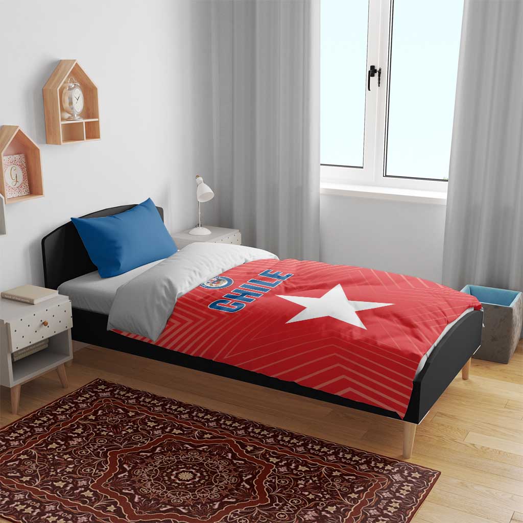 Chile-themed bedding on bed: red duvet with white star and CHILE text, blue pillows included