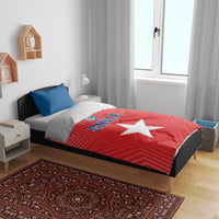 Chile-themed bedding on bed: red duvet with white star and CHILE text, blue pillows included